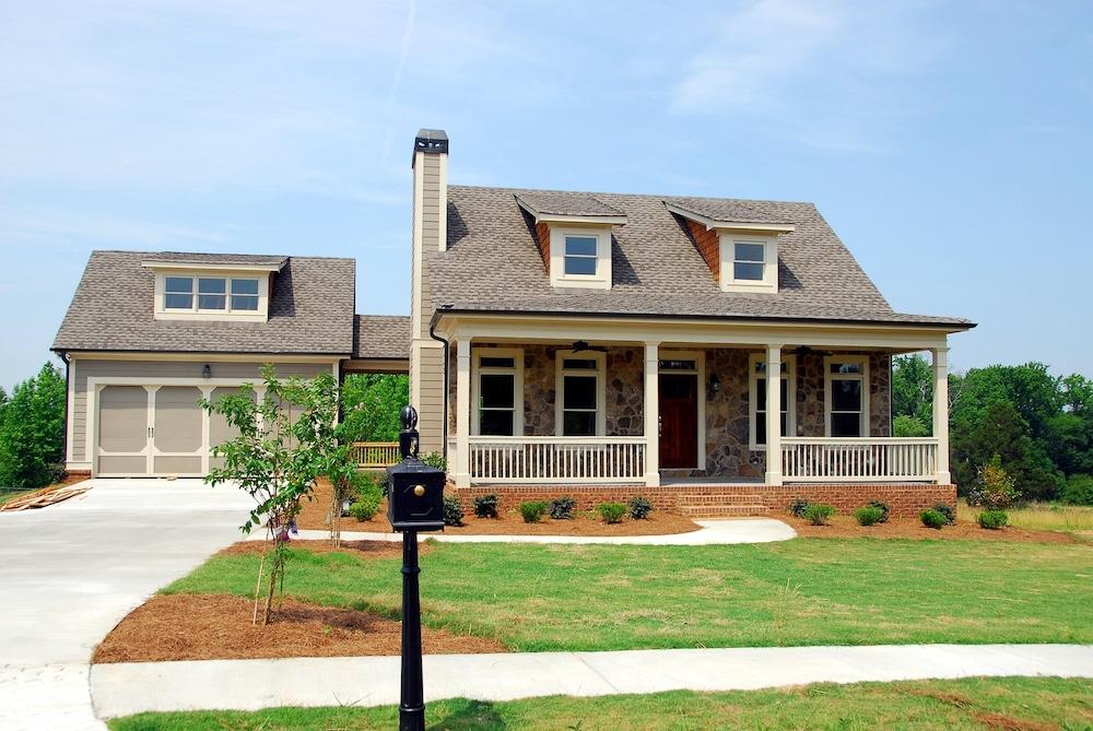 A beautifully rendered luxury property exterior showing a naturally integrated, soft sunset sky background